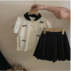 Capture d’écran, le 2026-07-01 à 15.36.49 ensemble-fille-polo-blanc-jupe-plissee-noire